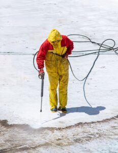 Electric pressure washer proper testing technique showing safe distance from various surfaces