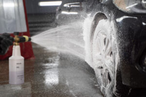 Step-by-step demonstration of proper car pressure washing technique with focus on correct angles and distances