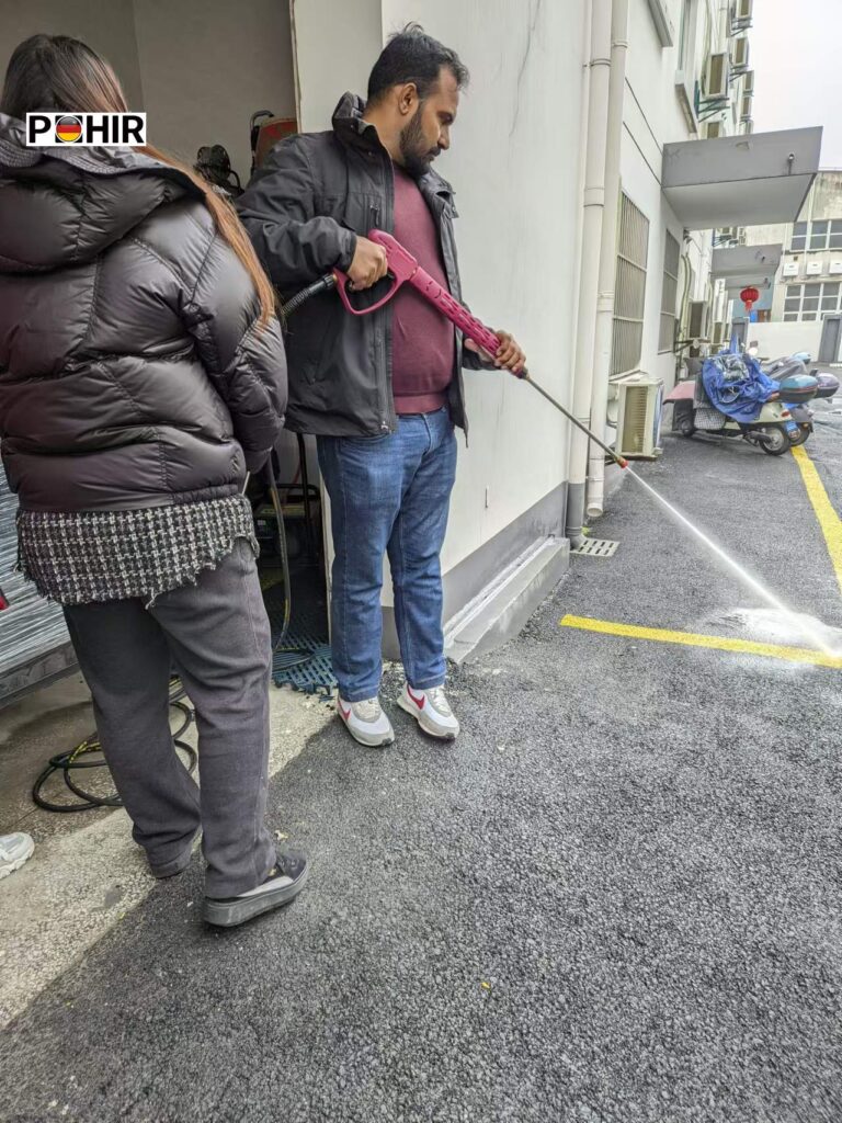 Multi-surface pressure washer cleaning concrete and metal