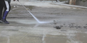 High flow pressure washer cleaning warehouse floor